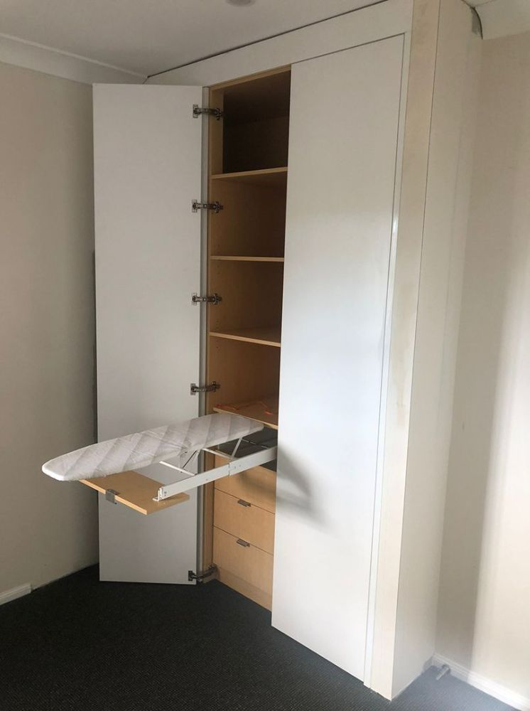 A Closet with A Folding Ironing Board Inside of It — Roll Edge In Manunda, QLD