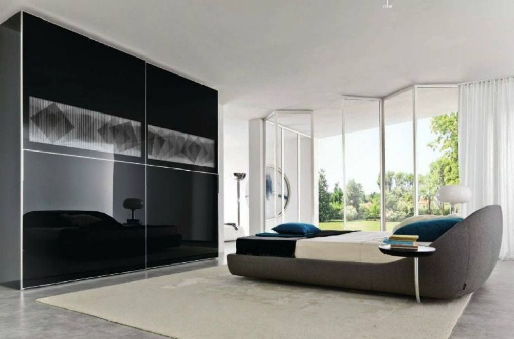 A Bedroom with Sliding Glass Doors and A Bed — Roll Edge In Manunda, QLD