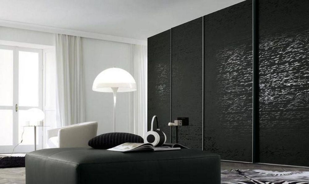 A Living Room with Black Sliding Doors and A Black Ottoman — Roll Edge In Manunda, QLD