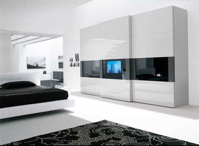 A Bedroom with A Bed and A Tv on The Wall — Roll Edge In Manunda, QLD