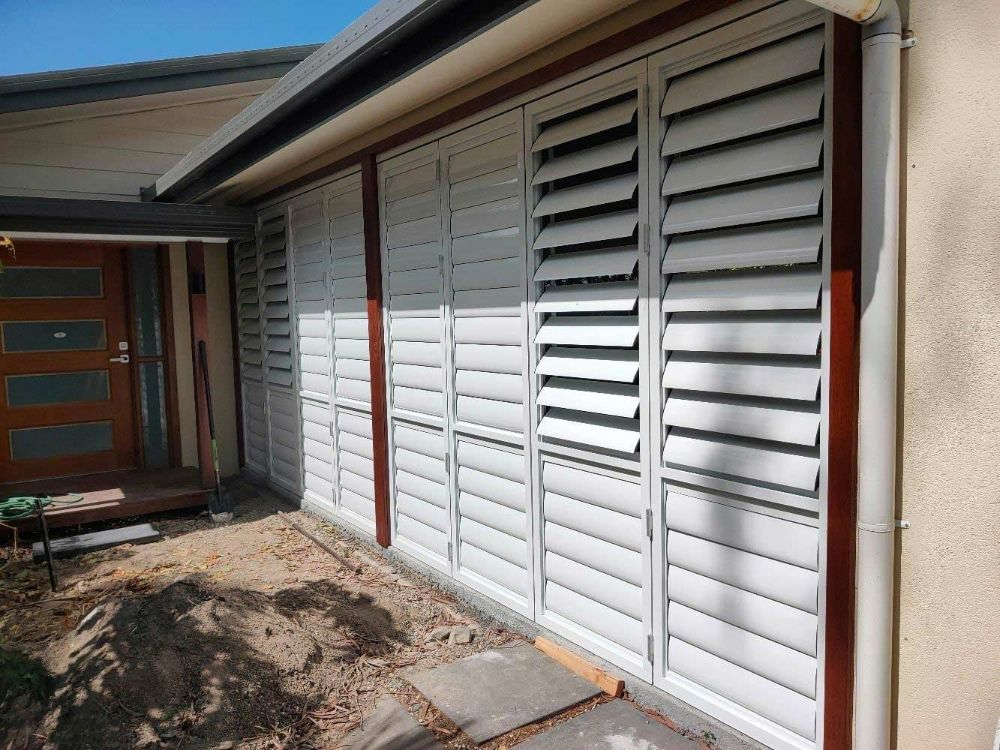 A House with White Shutters on The Side of It — Roll Edge In Manunda, QLD