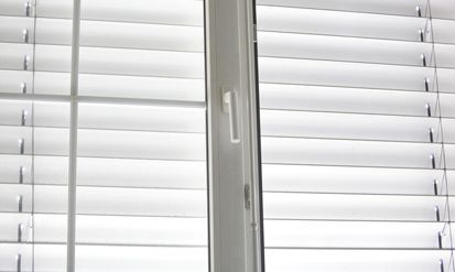 A Close up Of a Window with Blinds on It — Roll Edge In Manunda, QLD