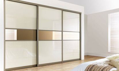 A Bedroom with Sliding Glass Doors and A Bed — Roll Edge In Manunda, QLD