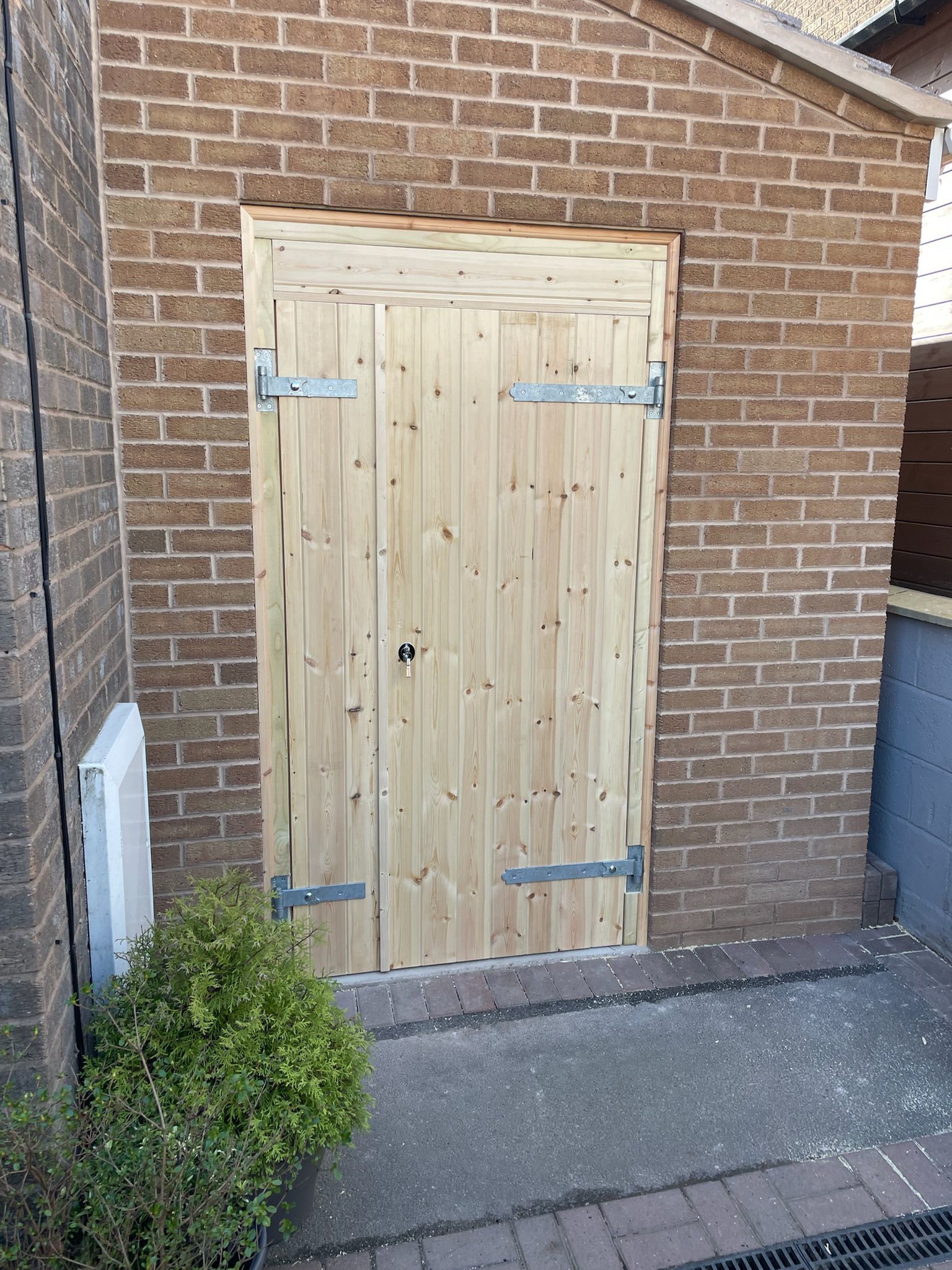 Derbyshire Joinery Specialists wooden garage door in Derby with key lock