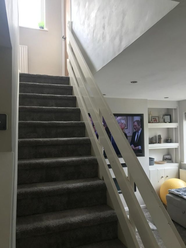 White painted staircase with horizontal rails before renovation