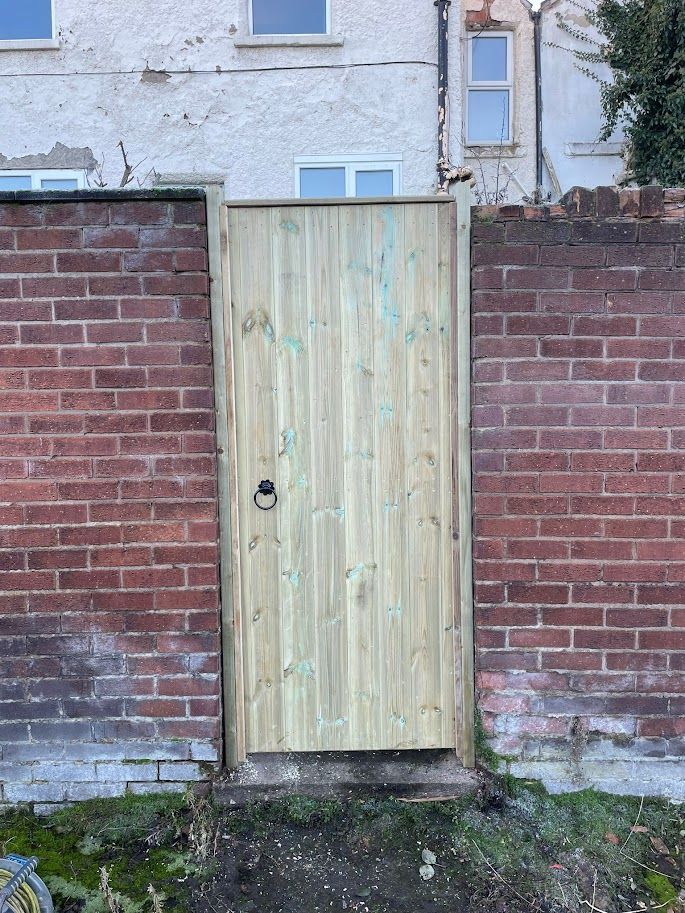 Derbyshire Joinery Specialists outside view of a wooden garden gate with lock