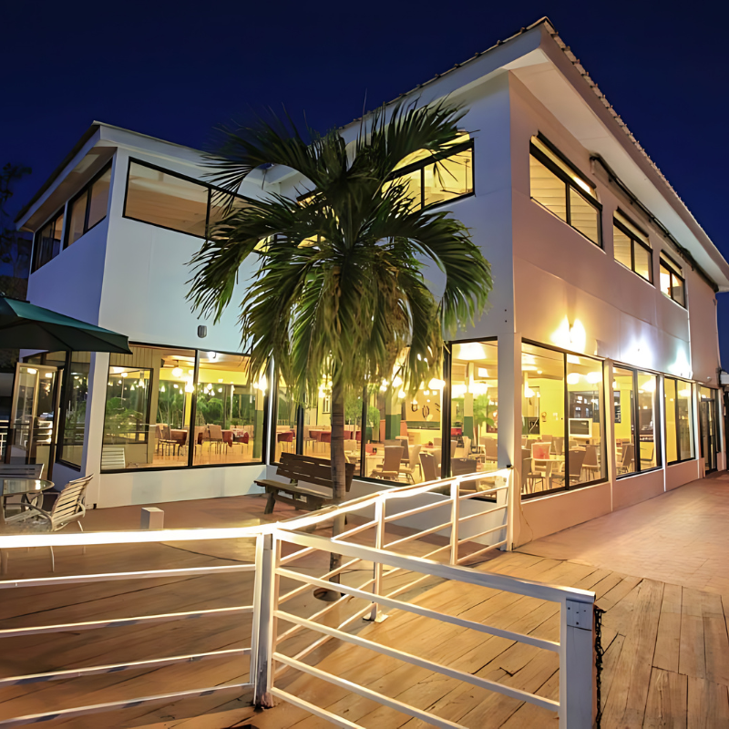 A large building with a palm tree in front of it