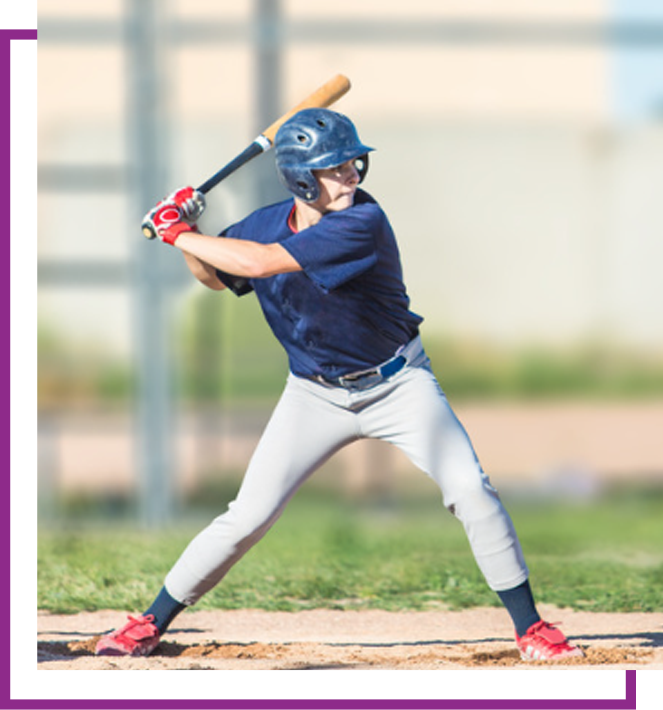 Baseball batter in blue uniform ready to swing at home plate