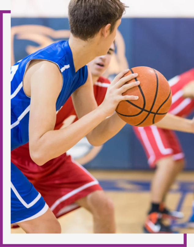 Basketball players in blue and red uniforms in action during a game