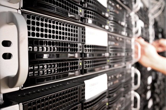 Picture of a computer technician working on business computer servers and IT solutions.