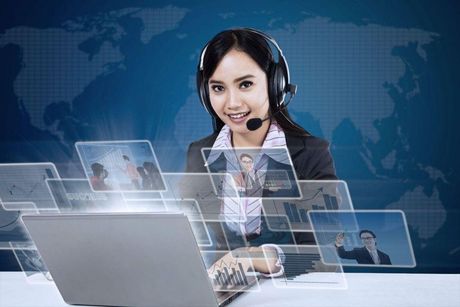 Picture of a woman providing remote technical support with images of a computer screen floating in front of her.