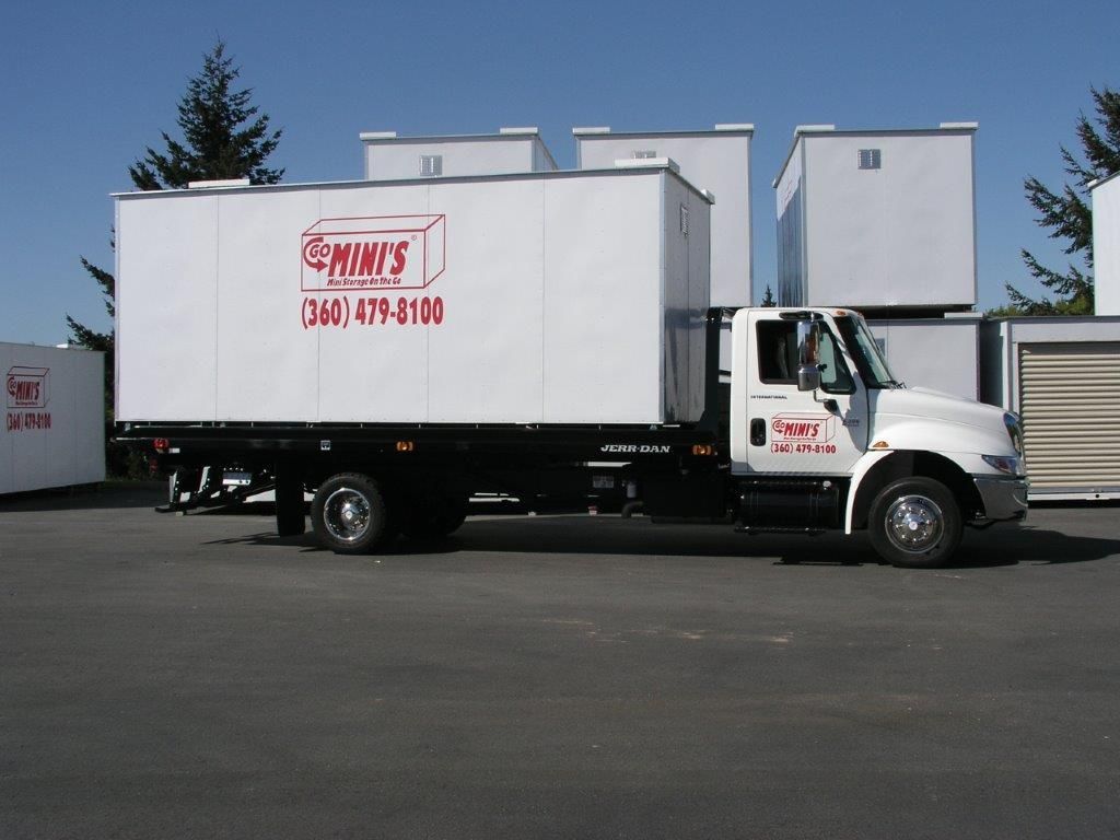White truck with storage container labeled