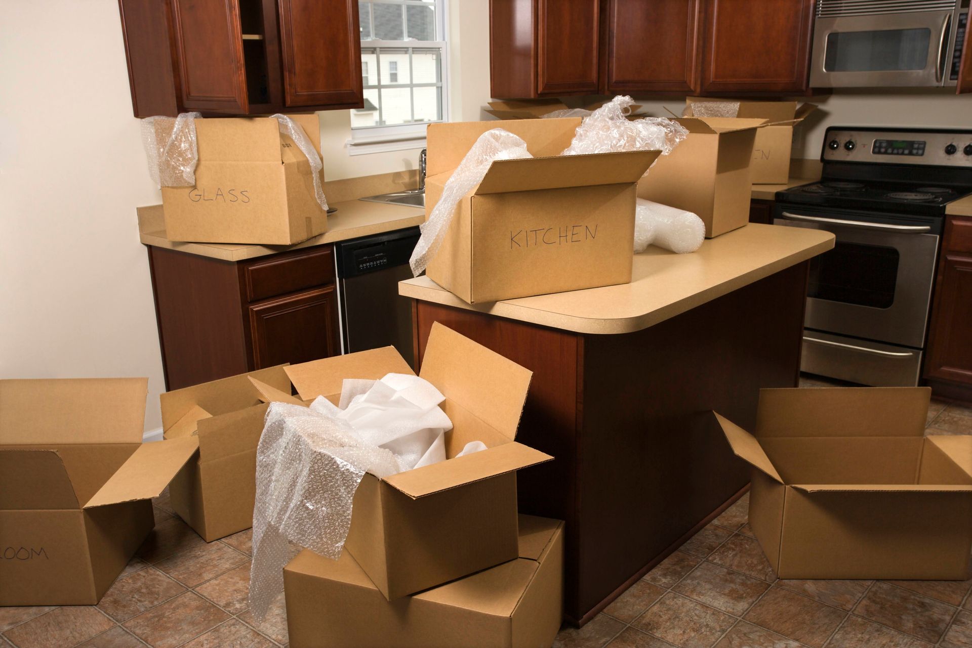 Kitchen filled with moving boxes, preparing for a move.