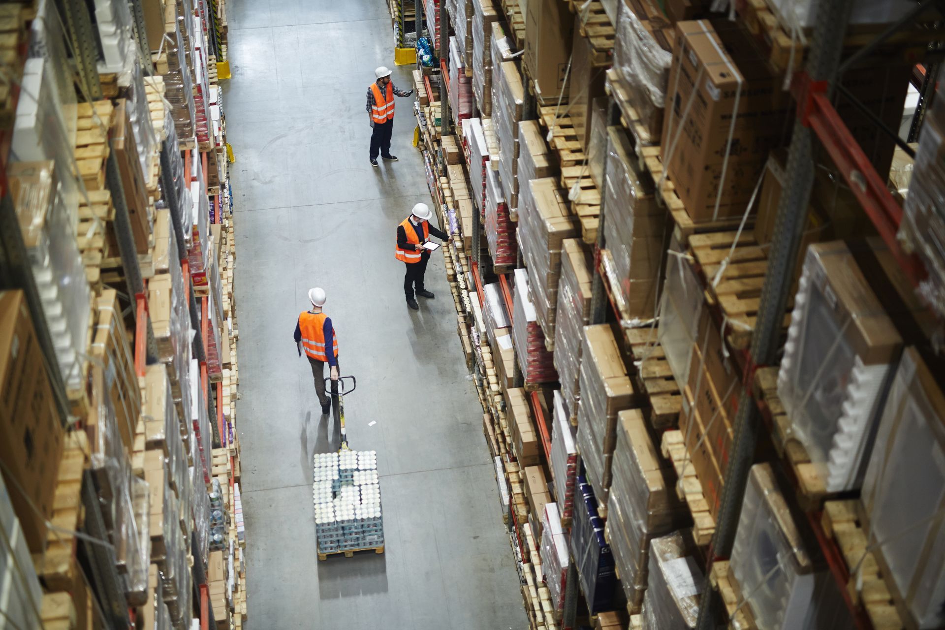 Above view of warehouse workers moving boxes.