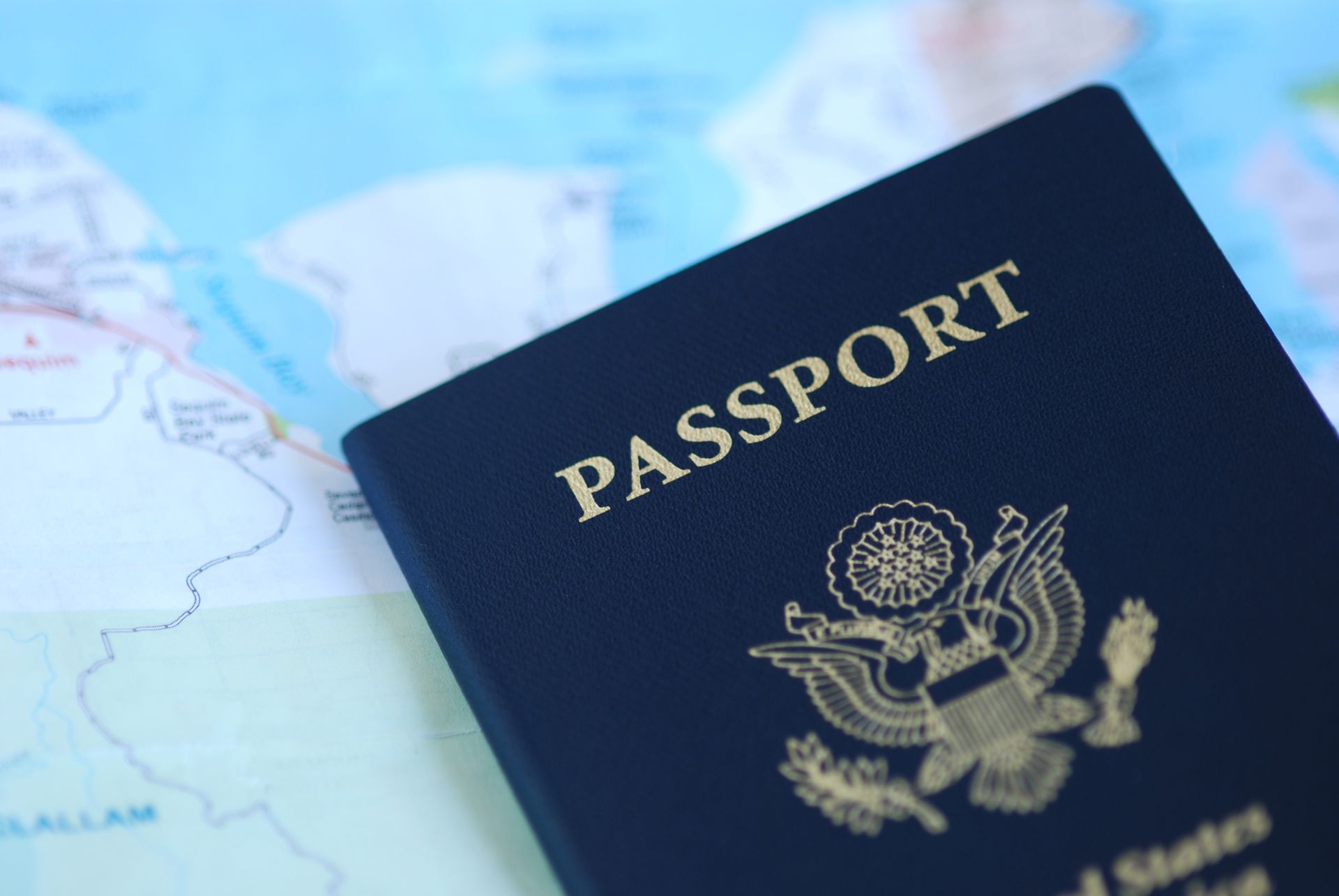 Blue passport on a world map, showing the United States seal.