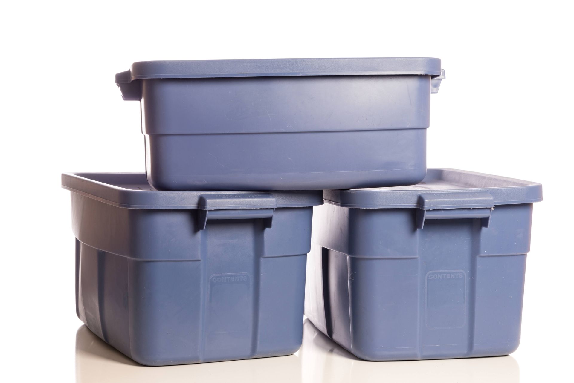 Three blue storage bins stacked on top of each other, ready for storage.