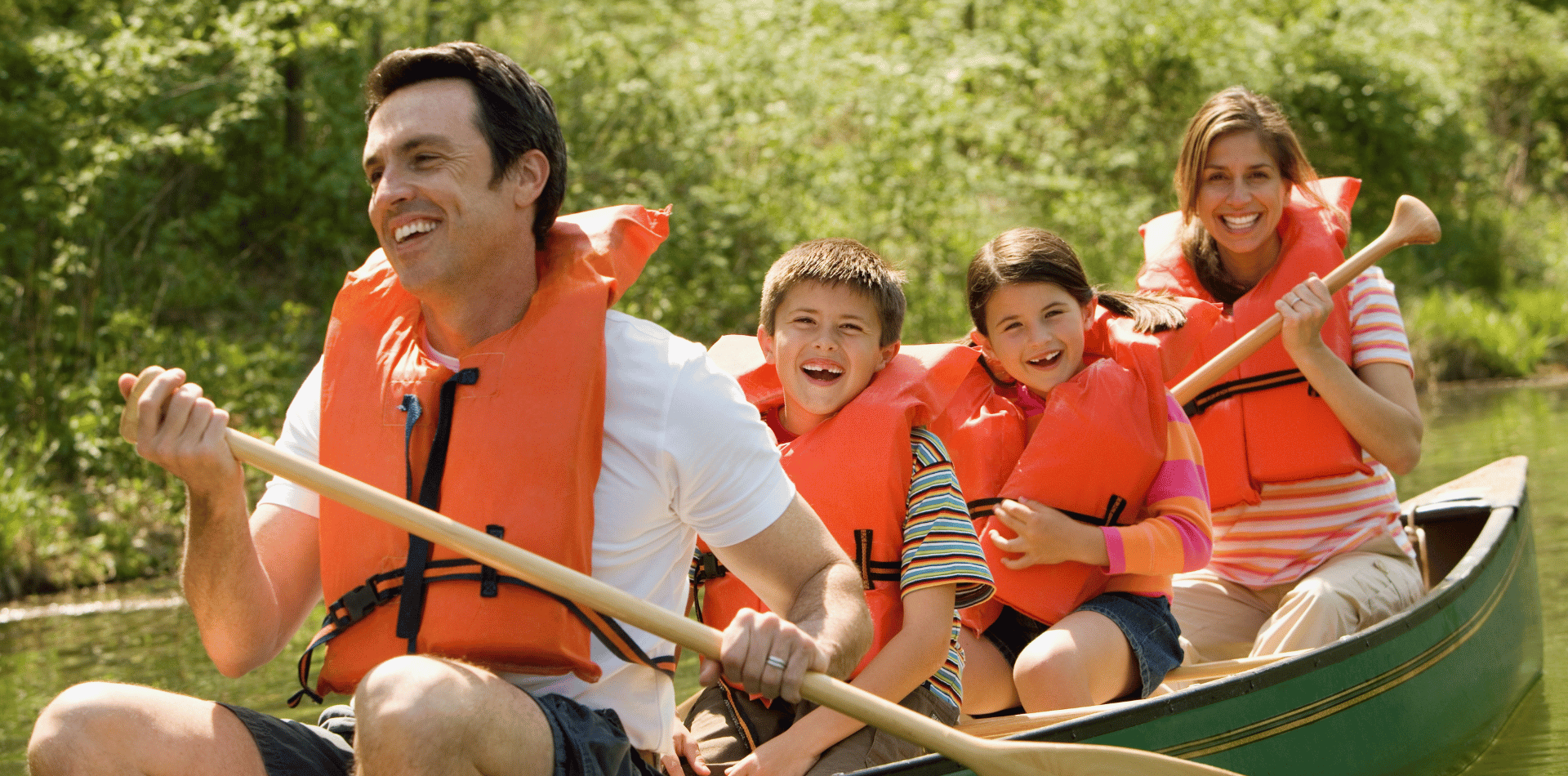 A family in a canoe wearing life jackets