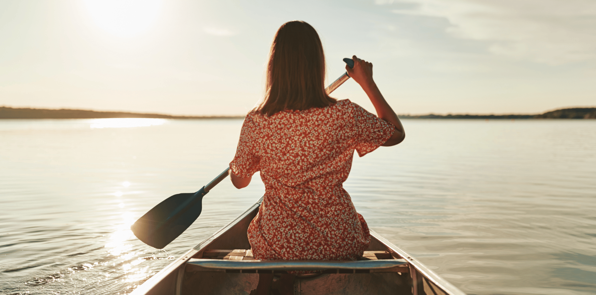 Woman paddling in a canoe