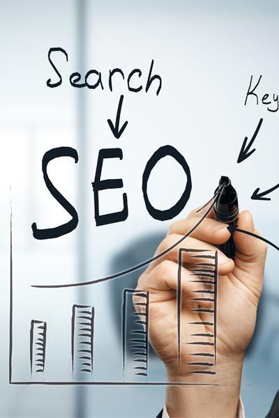 A person is writing search seo on a white board