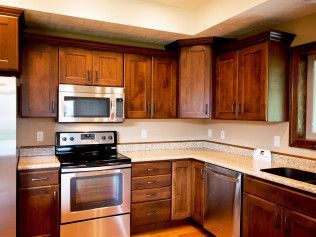 A kitchen with stainless steel appliances and wooden cabinets