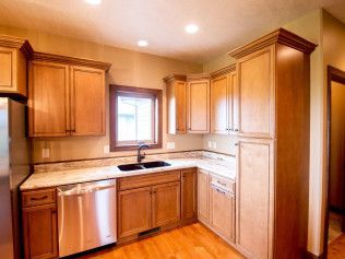 A kitchen with wooden cabinets and stainless steel appliances