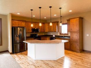 There is a large island in the middle of the kitchen.