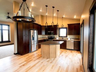 A kitchen with stainless steel appliances and wooden cabinets