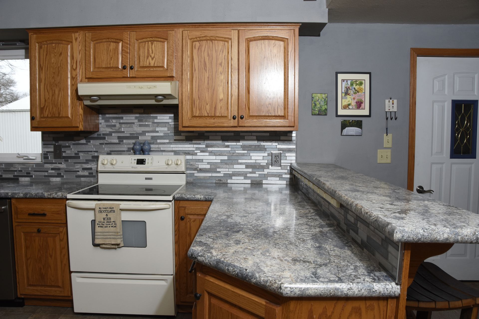 A kitchen with wooden cabinets and granite counter tops