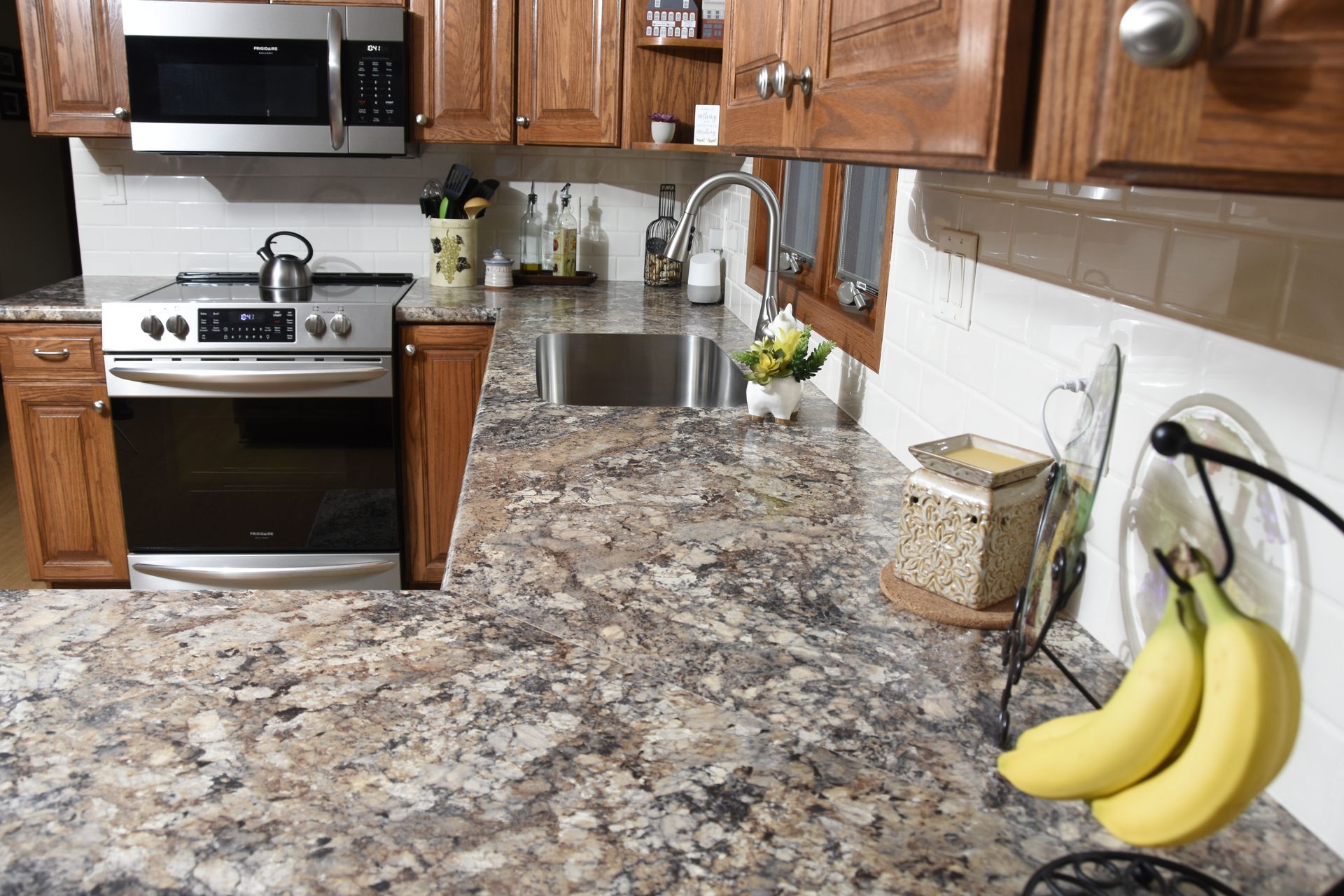 A kitchen with granite counter tops a stove and a sink