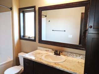 A bathroom with a sink , toilet , and mirror.