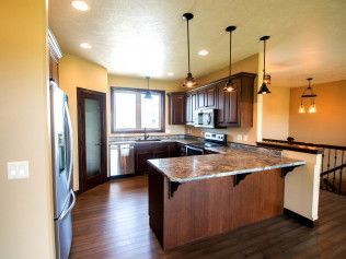 A kitchen with a large island and stainless steel appliances.