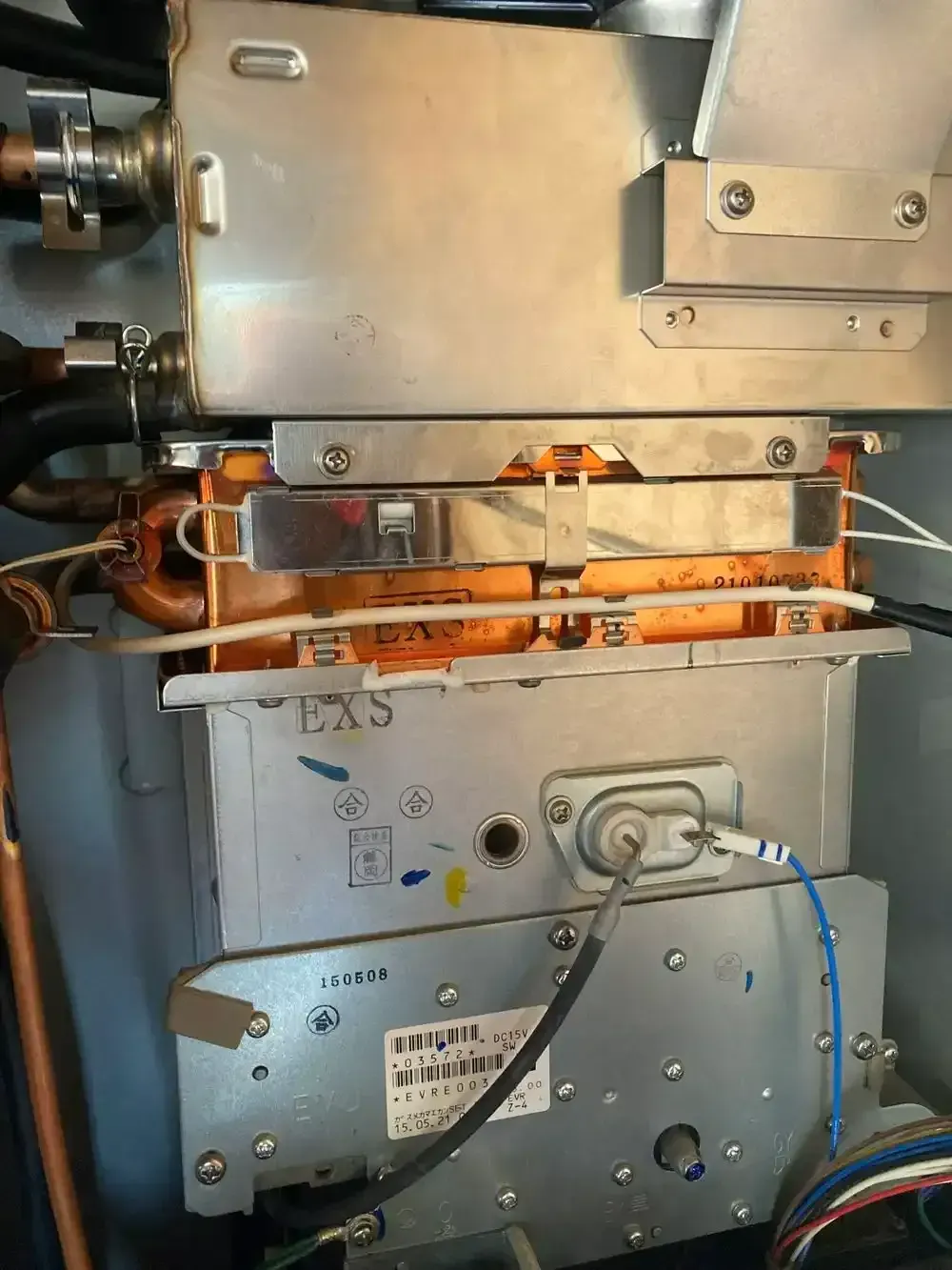 Close-up of industrial electronic equipment with metallic boxes, wiring, and a cable connected.