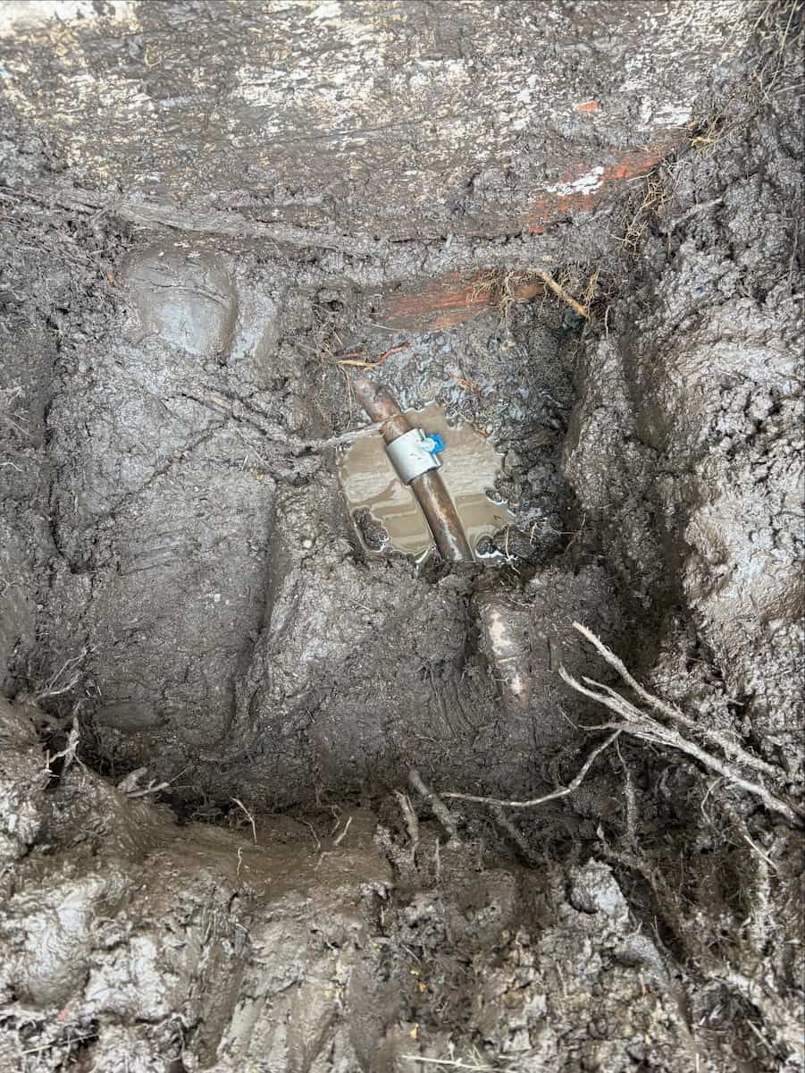 A Metal Pipe Connector Joins Two Segments of Copper Pipe — Crystal Clear Plumbing & Roofing in Fairy Meadow, NSW