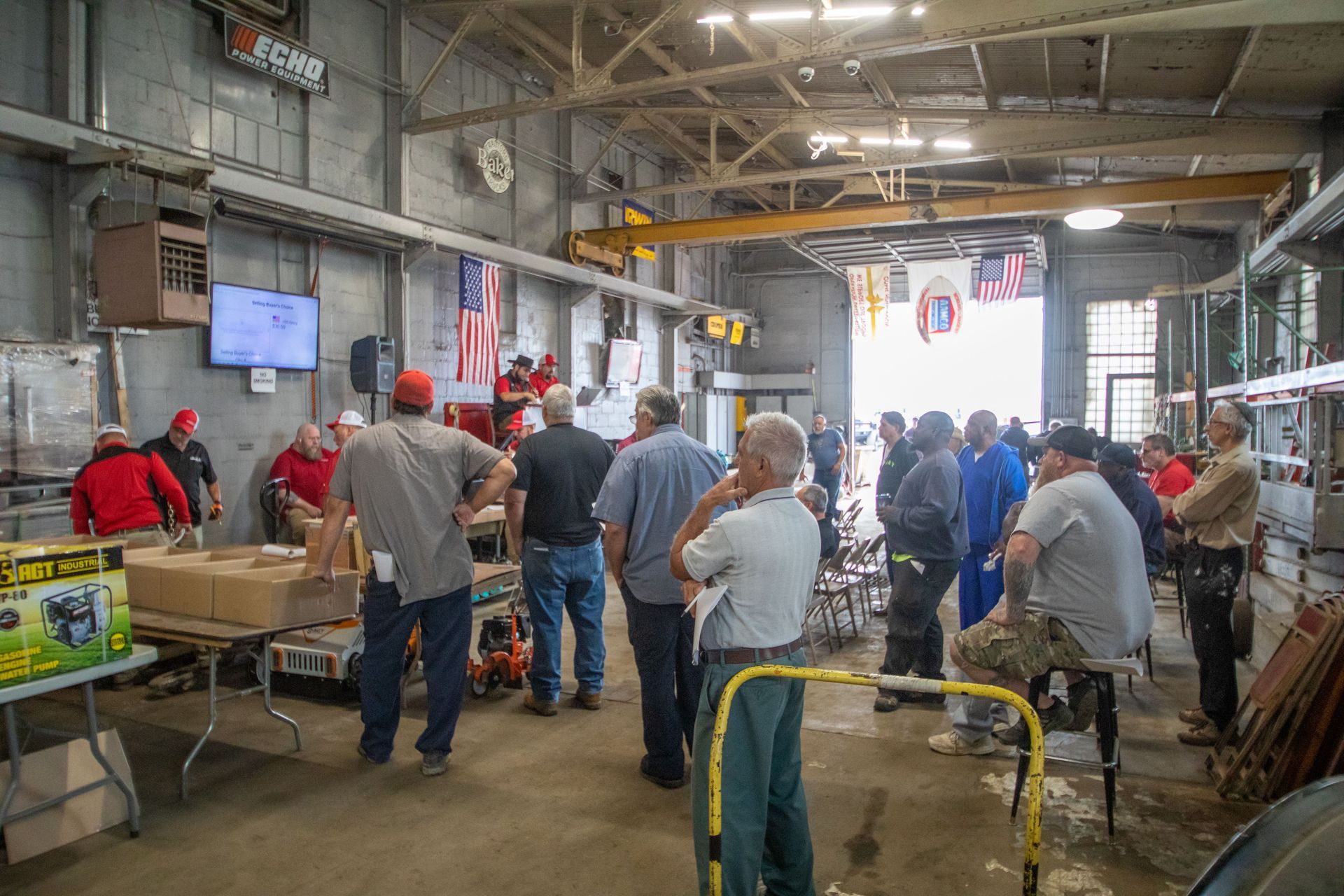 People gathered inside a large workshop, possibly a demonstration or training.