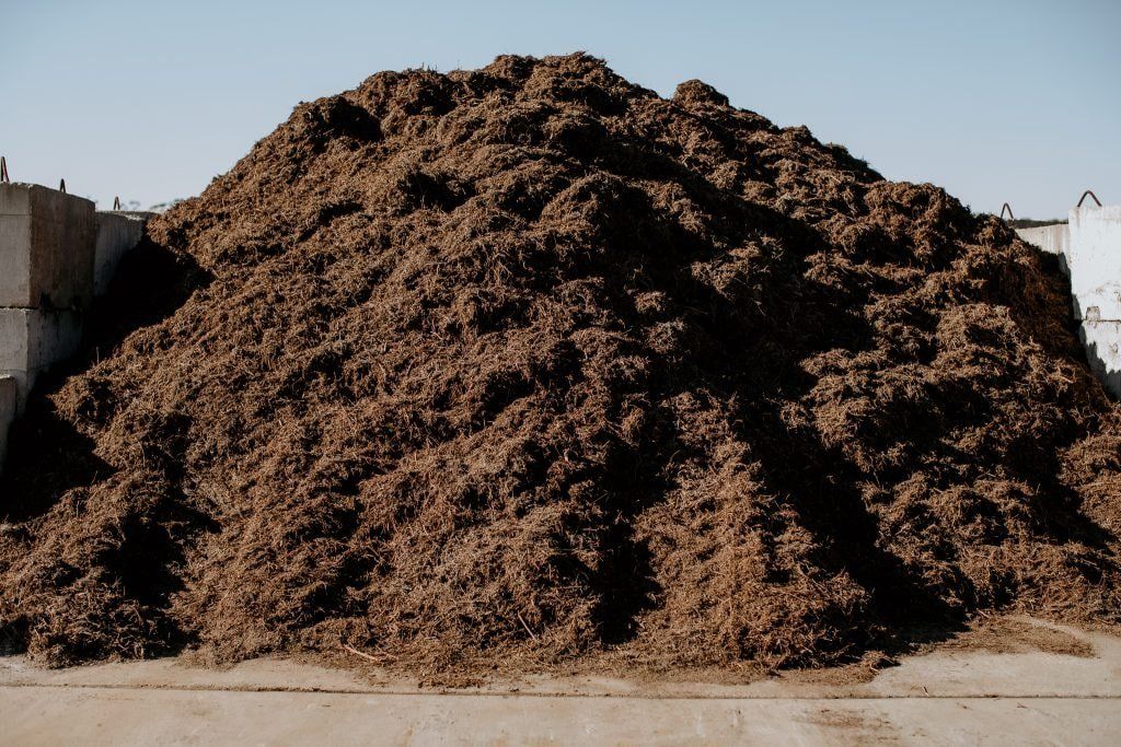 A Large Pile of Brown Dirt is Sitting on the Ground — Bonville Landscape Centre in Toorima, NSW