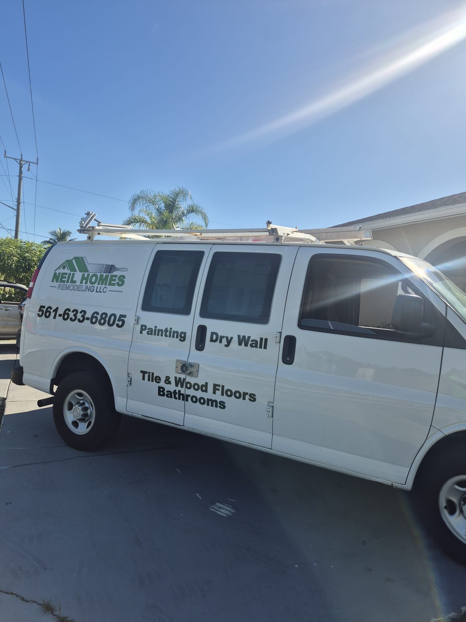White work van with logo for NSV Homes: painting, drywall, tile & wood floors. Phone number visible.