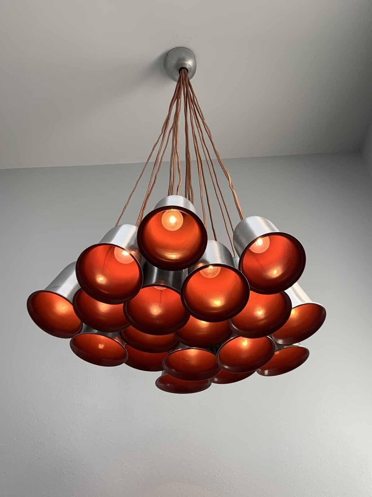 Cluster of copper pendant lights hanging from the ceiling in a modern room