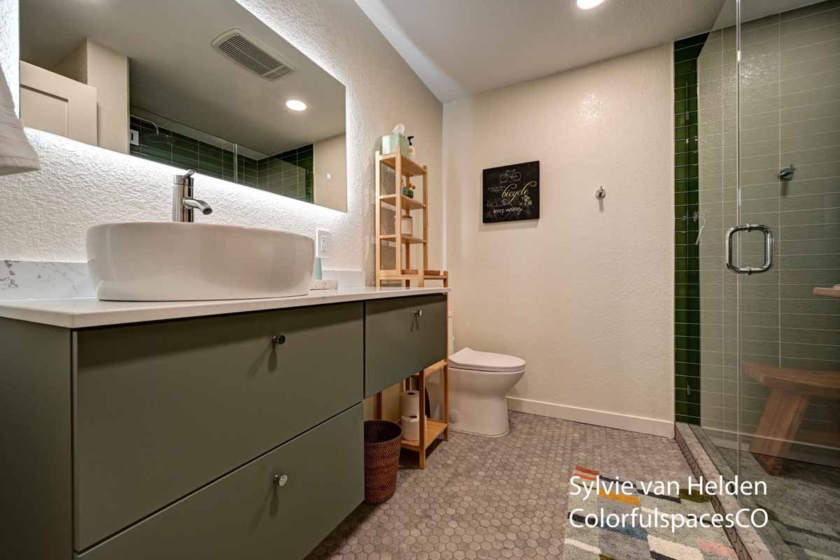 Modern bathroom with floating vanity, sink, toilet, and glass shower enclosure