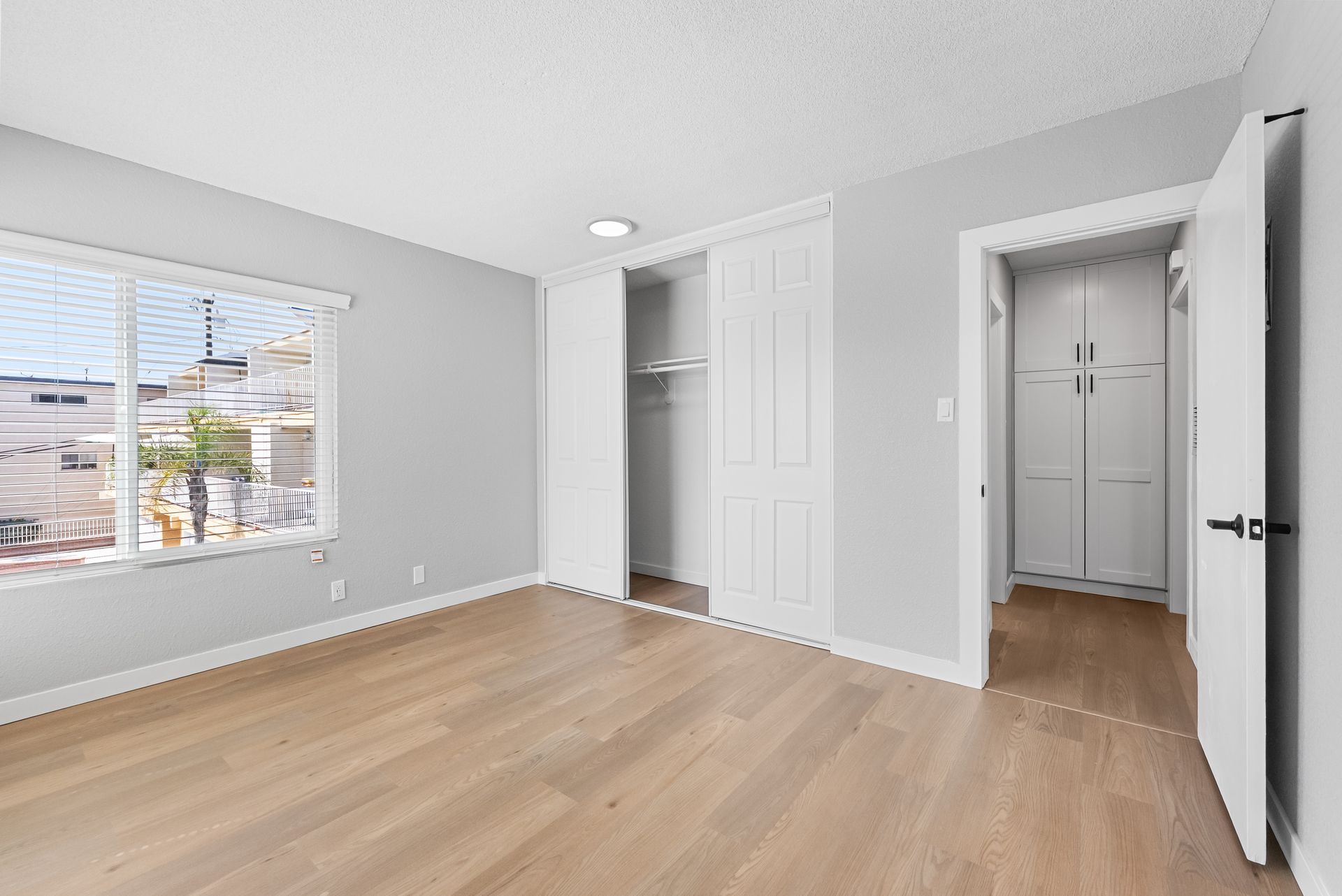 apartment bedroom with closet and open doorway