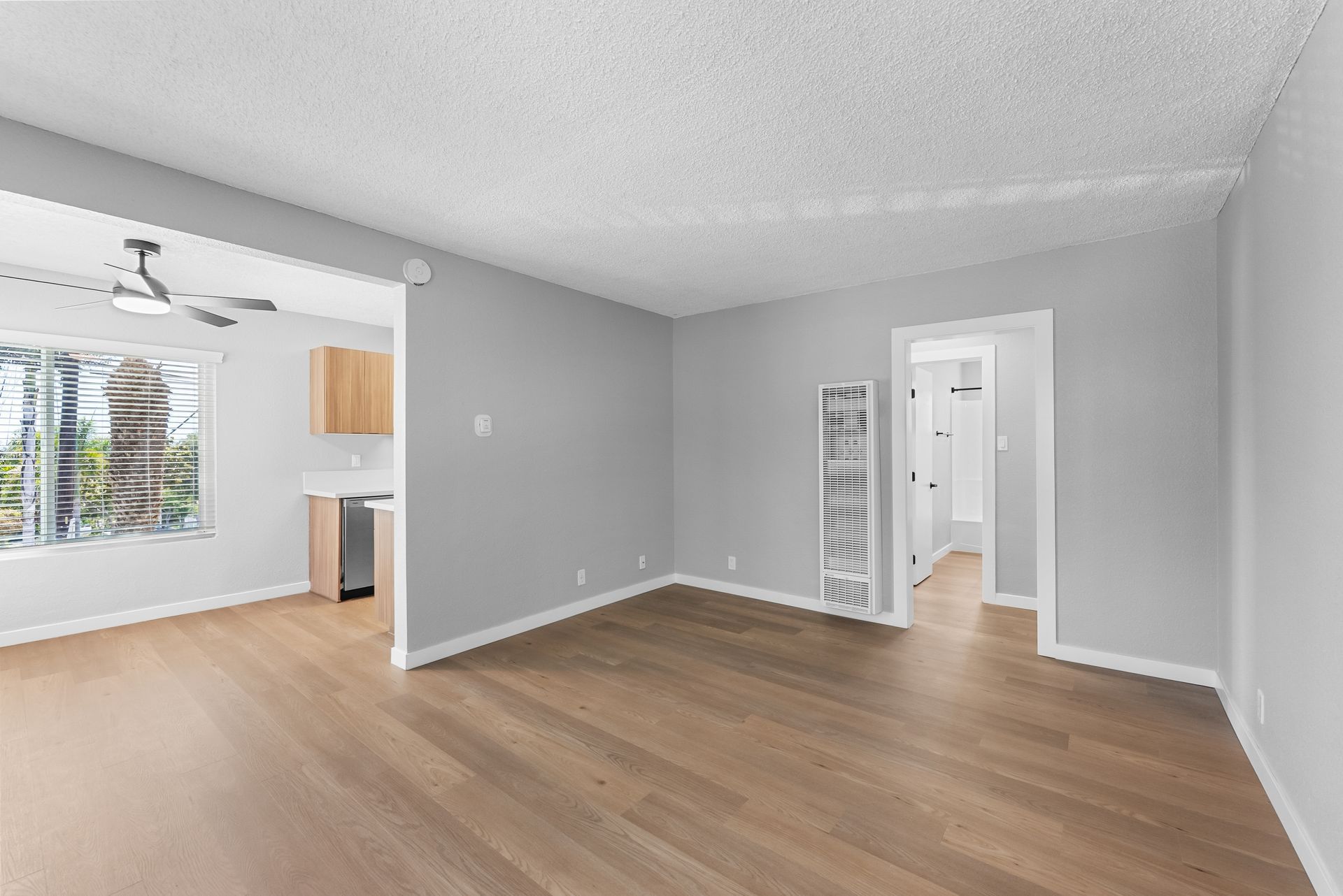 apartment living room with wood flooring and wall heater
