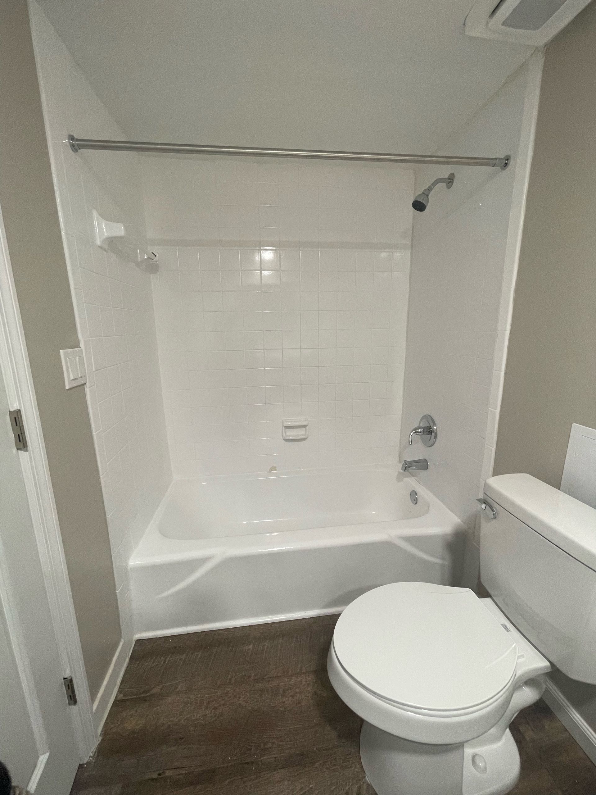 a bathroom with a toilet a bathtub and a shower