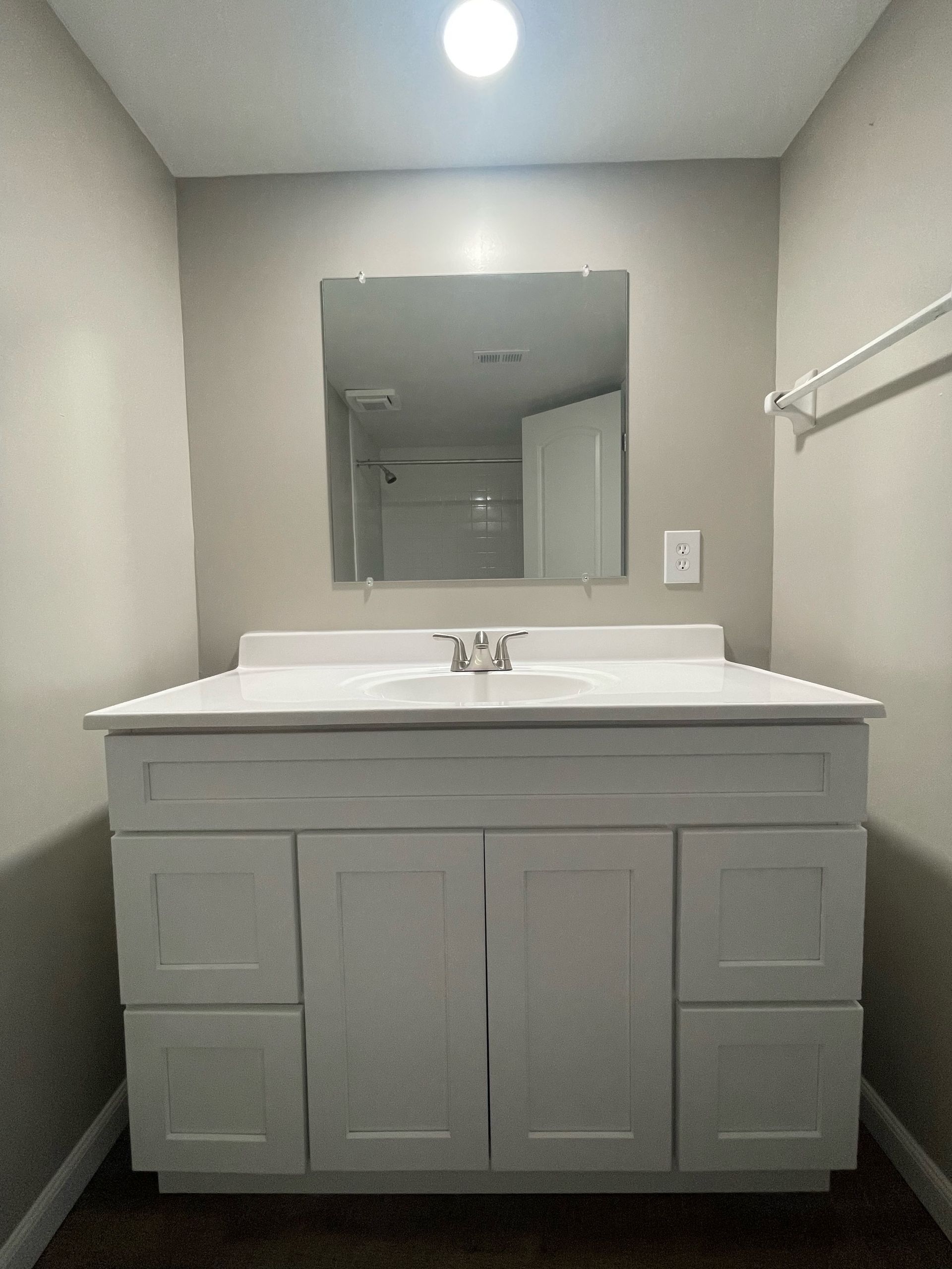 a bathroom with two sinks and a large mirror