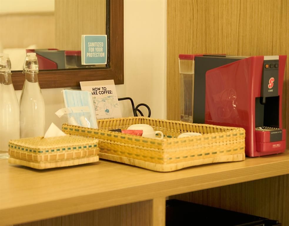 Wooden shelf with woven baskets, a red binder, and a small sign in a room