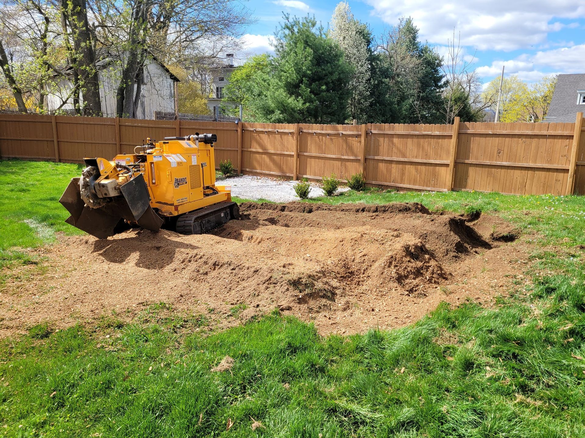 Stump grinding a residential backyard