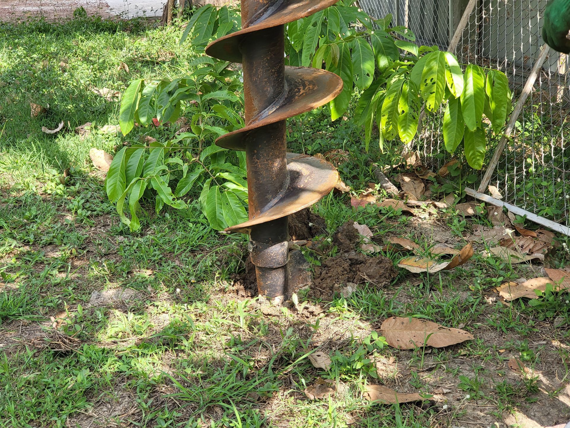 a drill bit is being used to dig a hole in the ground