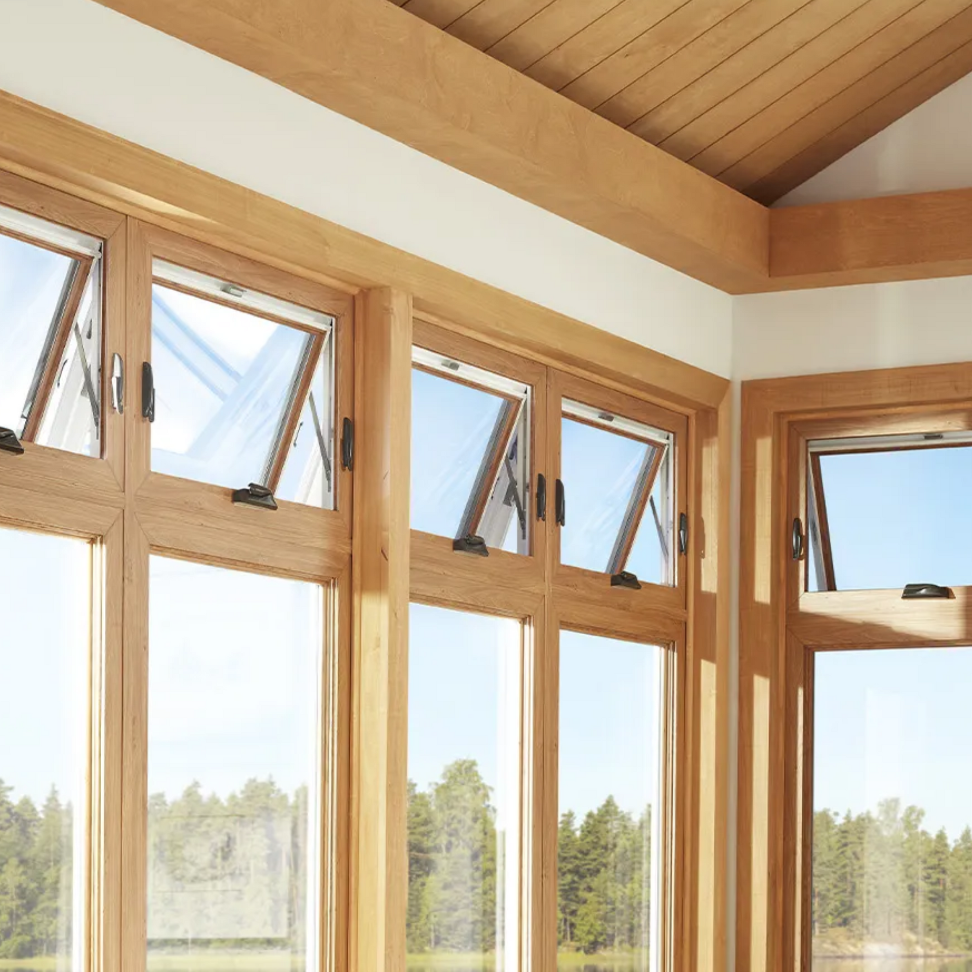 A room with lots of windows and a wooden ceiling