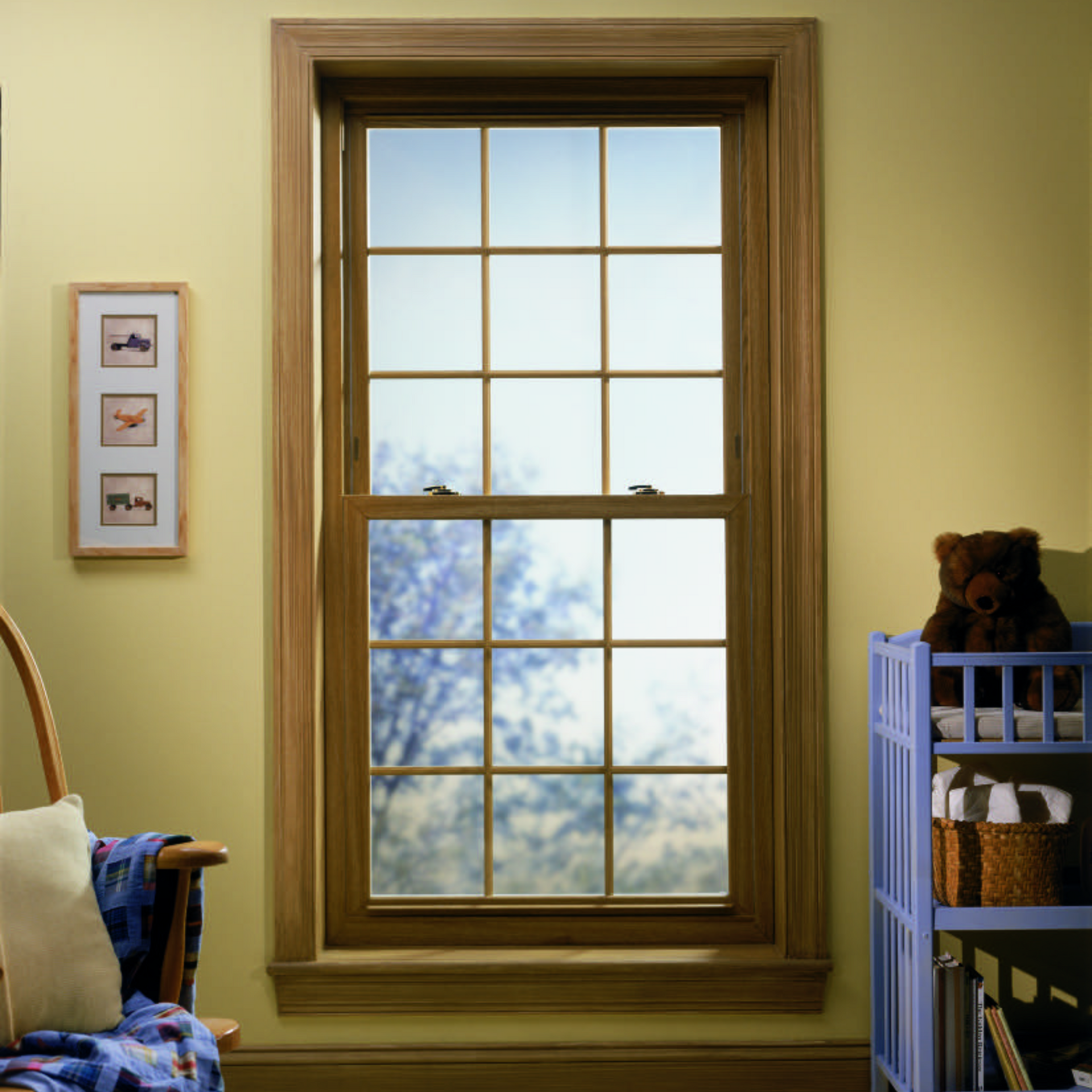 A child 's room with a large window and a blue crib