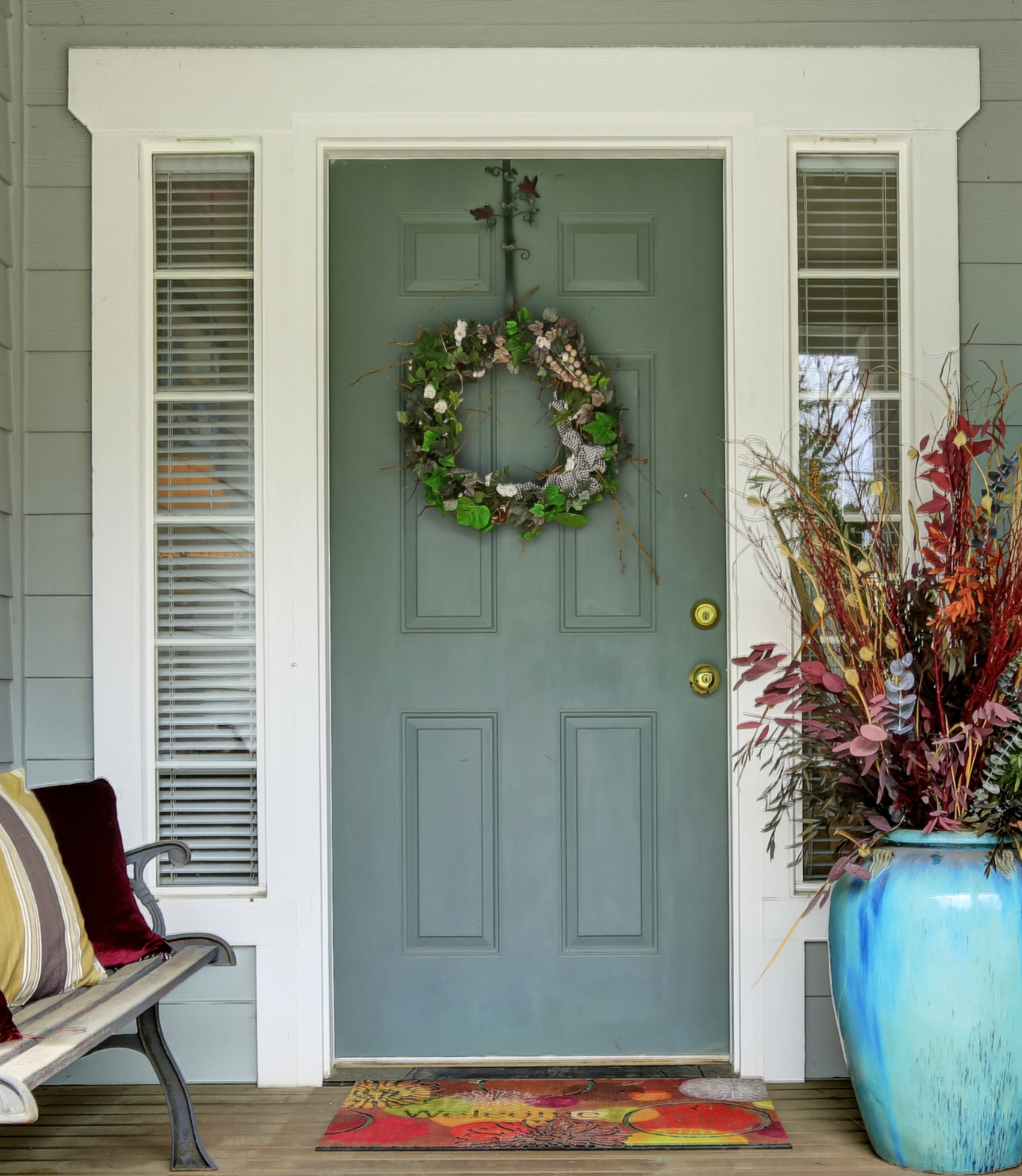 A blue door with a wreath hanging on it
