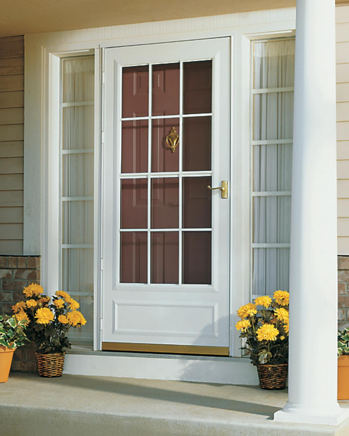A white door with yellow flowers in front of it