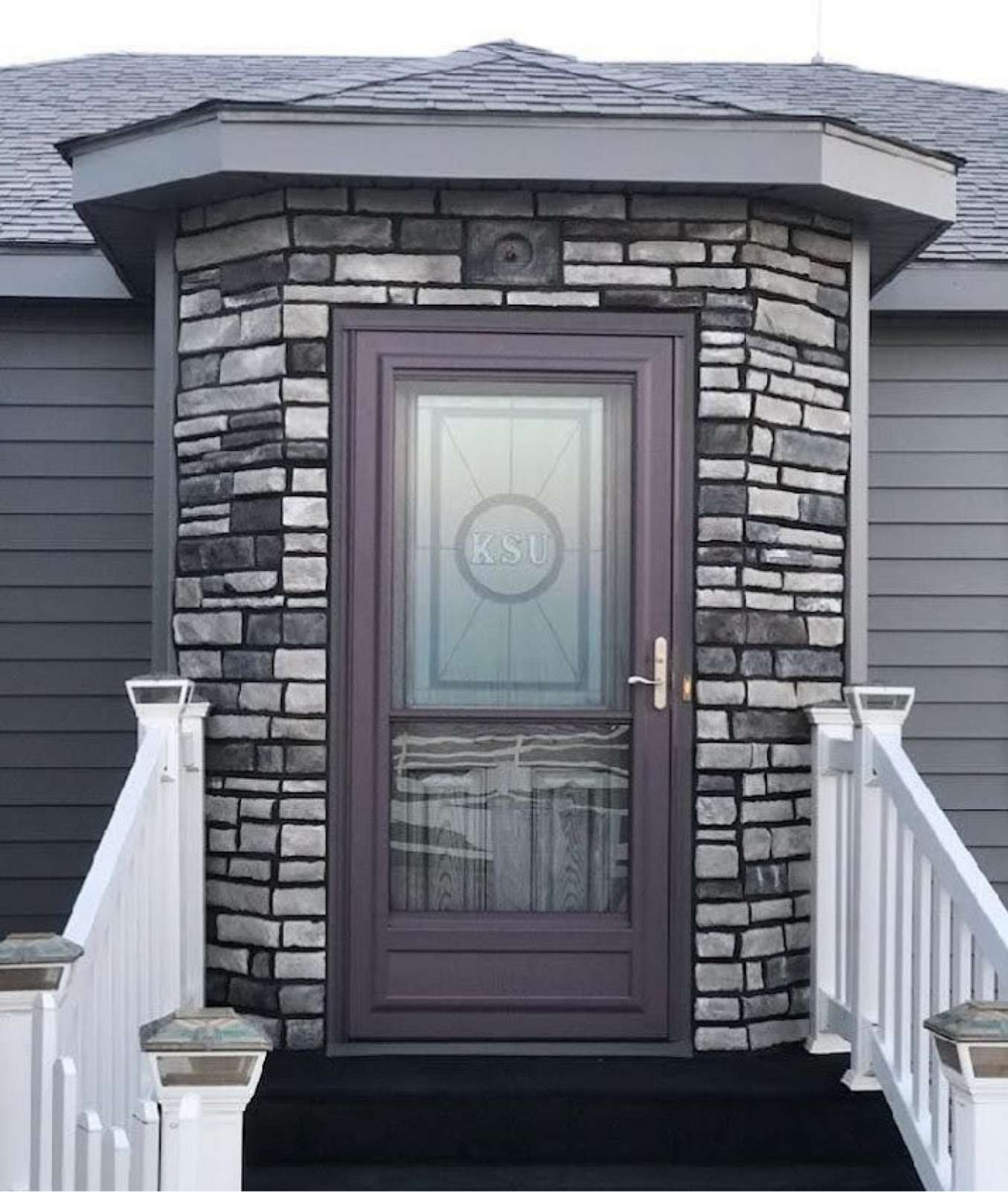 The front door of a house has the letters rsu on it